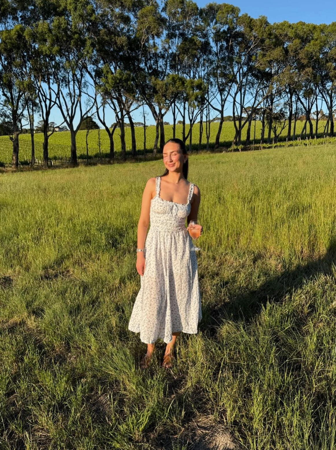 Client glowing in a sunlit vineyard
